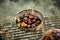 Man roasting a batch of fresh sweet chestnuts