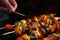 Man Roasting Skewers Of Colorful Vegetables On Open Flame Closeup. Generative AI