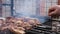 a man roasts meat on a fire. Close-up of hands and barbecue.