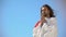 Man in robe praying to God against blue sky background, asking soul salvation