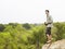 Man On Rock With Binoculars Looking At View