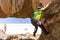 Man rock climbing stone cliff, Salar de Uyuni Bolivia.