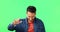 Man rocker with a punk gesture by green screen listening heavy metal music, playlist or album. Happy, portrait and male