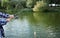 Man with rod fishing at riverside, closeup.