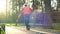 A man on rollers performs various revolutions between training cones. Professional roller skate training in the fall in