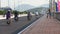 man rolls bike motorcyclists drive along bridge