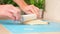 A man rolls yeast dough into pizza layer with a silicone rolling pin on mat. Cooking homemade pizza.