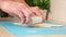 A man rolls yeast dough into pizza layer with a silicone rolling pin on mat. Cooking homemade pizza.