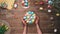 Man rotating basket with easter eggs on table decorated with easter eggs. Top view