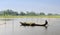 A man rowing boat on the field at flood season in Tra Vinh province, Vietnam