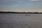 Man rowing on a boat on a lake at dusk