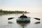 Man rowing inflatable rubber fishing boat on river, back view