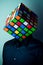 Man with a Rubik`s cube puzzle for head