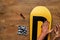 Man rubs snowboard sponge wax on wooden floor