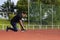 Man runner doing stretching exercise, preparing for morning workout