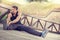 Man runner stretching legs before exercise run on wooden footbridge