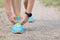 Man runner ties shoelaces on the ground with hands