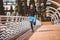 Man running along  modern bridge. Exercising, Jogging, Sport. Male athlete running