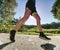 Man running on asphalt track. Athlete running fast in a park