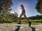 Man running on asphalt track. Athlete running fast in a park