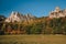 Man running on the autumn meadow near by majestic rocky hills