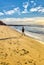 Man running in the beach at dawn soft waveâ€™s bright blue sky, foot prints trace in sand