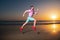 Man running on the beach at sunset. Guy runner jogger running. Dynamic jumping movement. Sport jump.