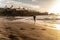 Man running at the beach at sunset light alone. Island vibes. Healthy lifestyle concept