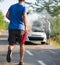 Man running with a car extinguisher to help another driver to extinguish car fire