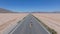 Man running down the endless road in the desert. Aerial view of the infinity.