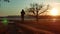 Man running down the road at sunset standing alone tree silhouette. Athletic young man running in the nature in Pine the