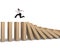 Man running on falling wooden dominoes
