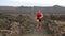 Man running outdoor sprinting for success. Male fitness runner on lava trail. Sport athlete in sprint at great speed in