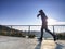 Man is running quickly on the shore bridge. Silhouette of active man