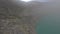 Man running in respiratory mask tropical island volcano dive to crater acid lake at fog aerial view