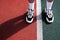 A man in running shoes stands at the stadium at the start line. the athlete is preparing for the competition. legs in sneakers clo