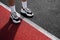 A man in running shoes stands at the stadium at the start line. the athlete is preparing for the competition. legs in sneakers clo