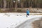 The man running on snow on the river bank