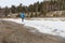 The man running on snow on the river bank