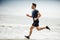 Man running on sunny beach