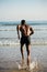 Man running to the sea for swimming training