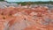 A man running on top of a clay mountain - unusual landscape