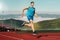 Man running in the track. Fit male fitness runner jogging in stadium