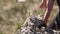 The man runs and jumps over the stone. Close-up of a hand on a stone