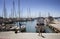 Man runs by Palma de Mallorca marina. Many yachts parked. It`s a