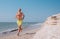 Man runs on the sea surf line barefoot