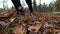 A man runs uphill over some leaves in autumn in slowmotion