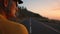 The man`s face, the cyclist in the yellow shirt in the mountains looking at the sunset. Resting after a workout, iron