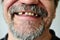 Man\'s face with a smiling toothless