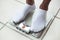 Man\'s feet on bathroom scale. Diet concept